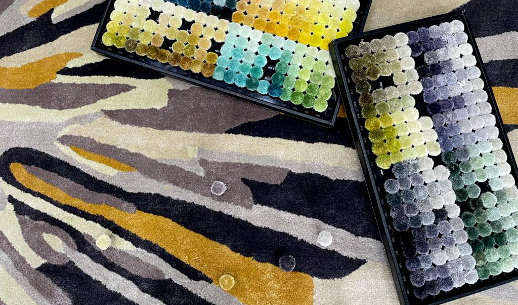 Monochrome rugs styled in a tone-on-tone interior, featuring layered textures in neutral shades like ivory, charcoal, and taupe to create subtle depth and quiet luxury.