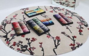 Runway inspired rugs featuring bold, couture-driven colors and patterns influenced by 2025 fashion trends, styled in a high-fashion interior setting.