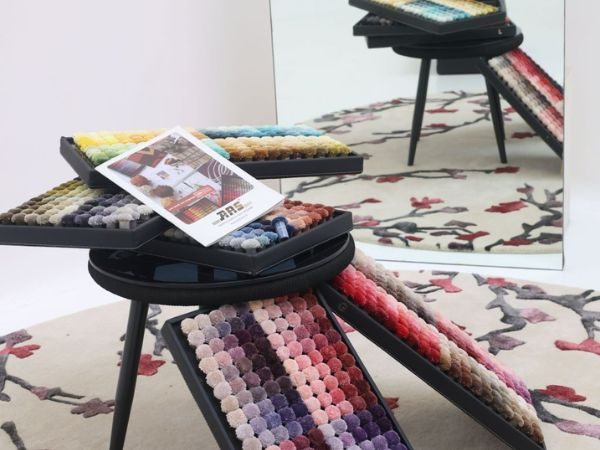 Ars blog (1) Runway inspired rugs featuring bold, couture-driven colors and patterns influenced by 2025 fashion trends, styled in a high-fashion interior setting.